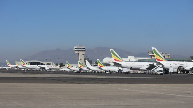 a group of airplanes at an airport