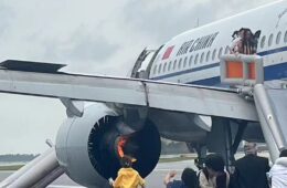 a group of people standing around an airplane