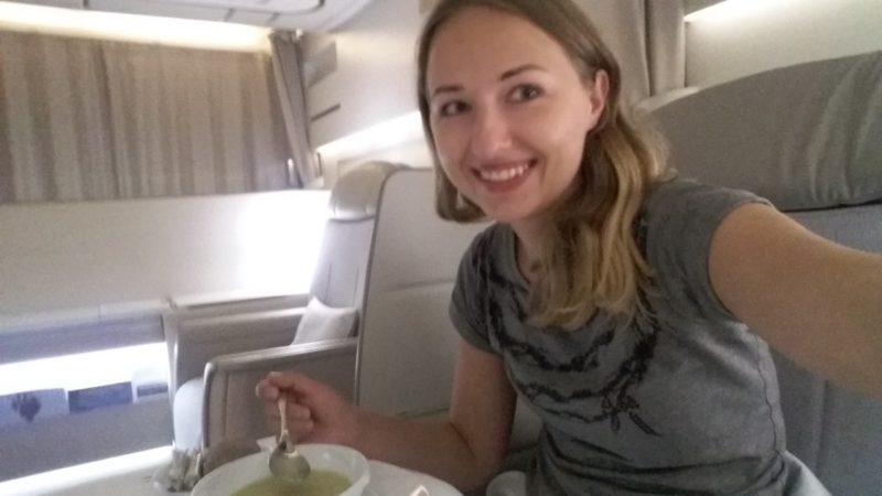 a woman sitting at a table with a spoon in her hand