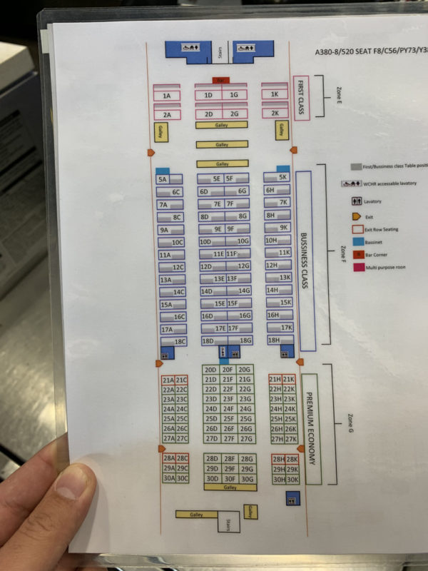 a hand holding a piece of paper with a diagram