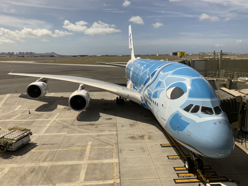 a blue airplane on a runway