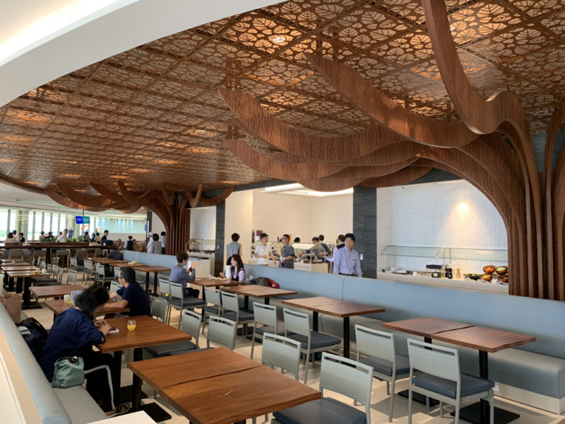 a group of people sitting at tables in a restaurant