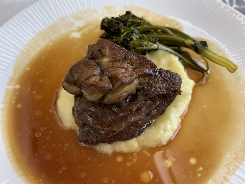 a plate of food with broccoli and meat