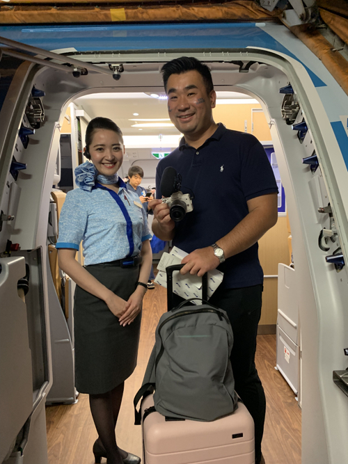 a man and woman standing in an airplane