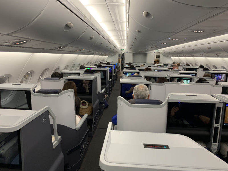 a group of people sitting in an airplane