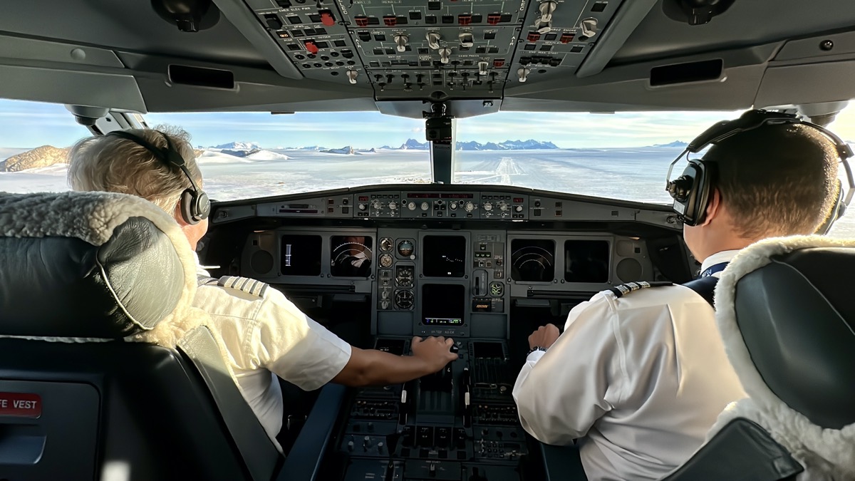 two men in a cockpit of an airplane