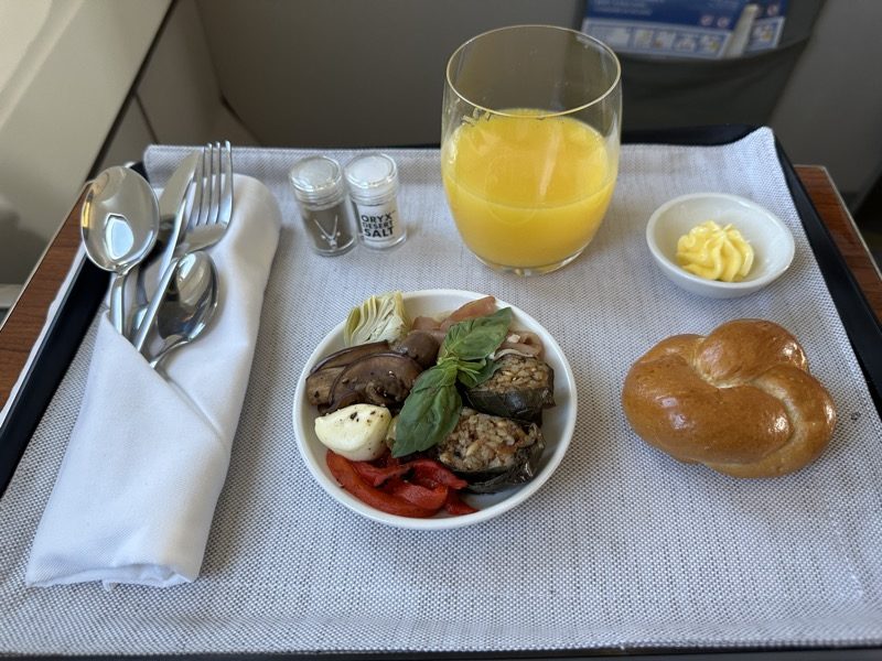 a plate of food and a glass of juice on a table