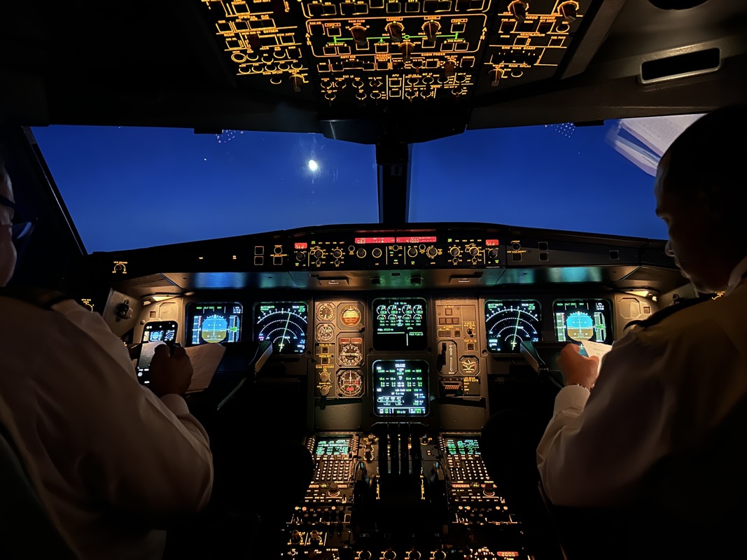 a cockpit of an airplane with people in it