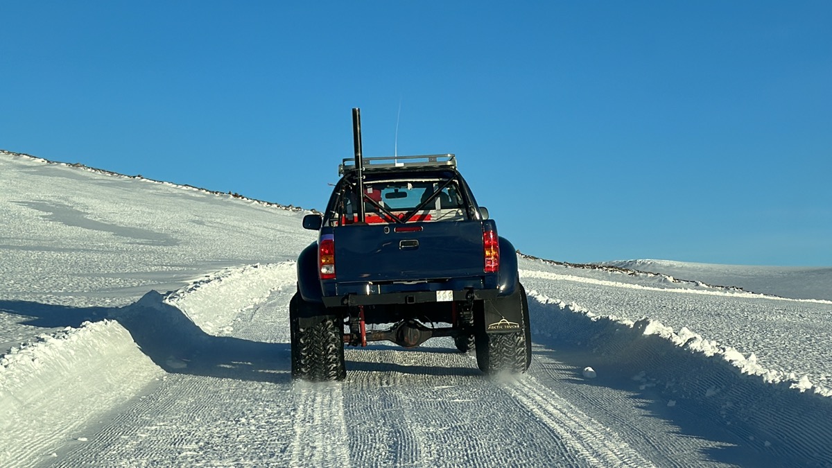 a truck driving on a snowy road