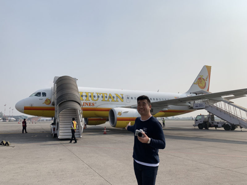 a man standing in front of an airplane