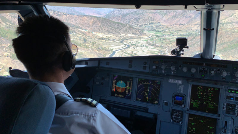 a man in a uniform in a cockpit