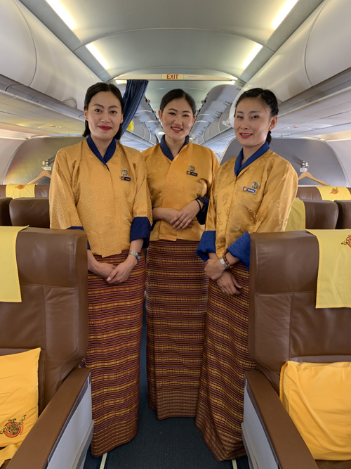 a group of women in uniforms standing in a row of chairs