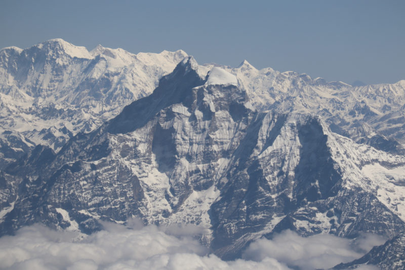 a snowy mountain range with clouds