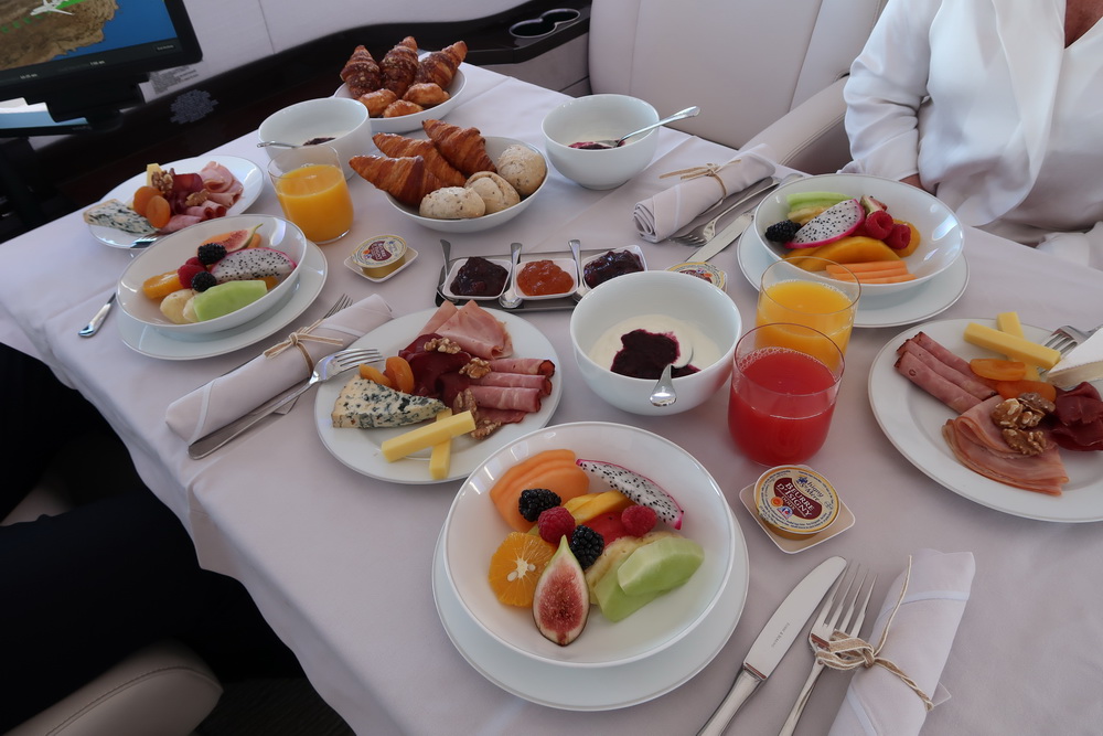 a table with plates of food and drinks