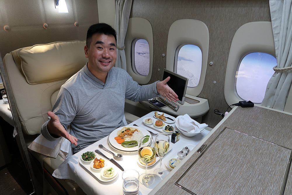 a man sitting at a table with food on it