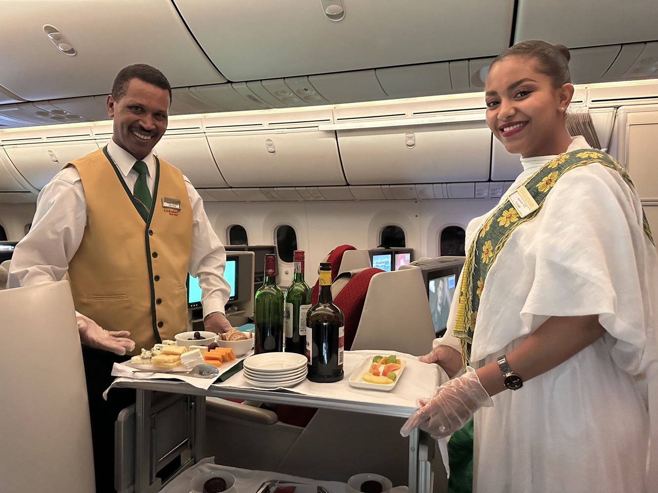 a man and woman standing next to a tray of food