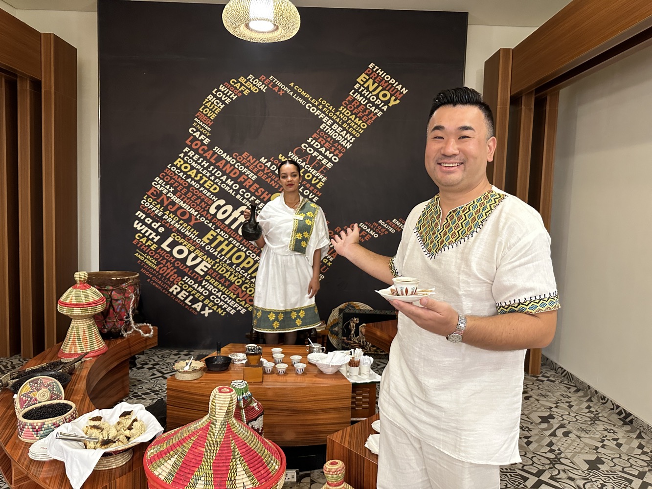 a man and woman in a room with a teapot and cups