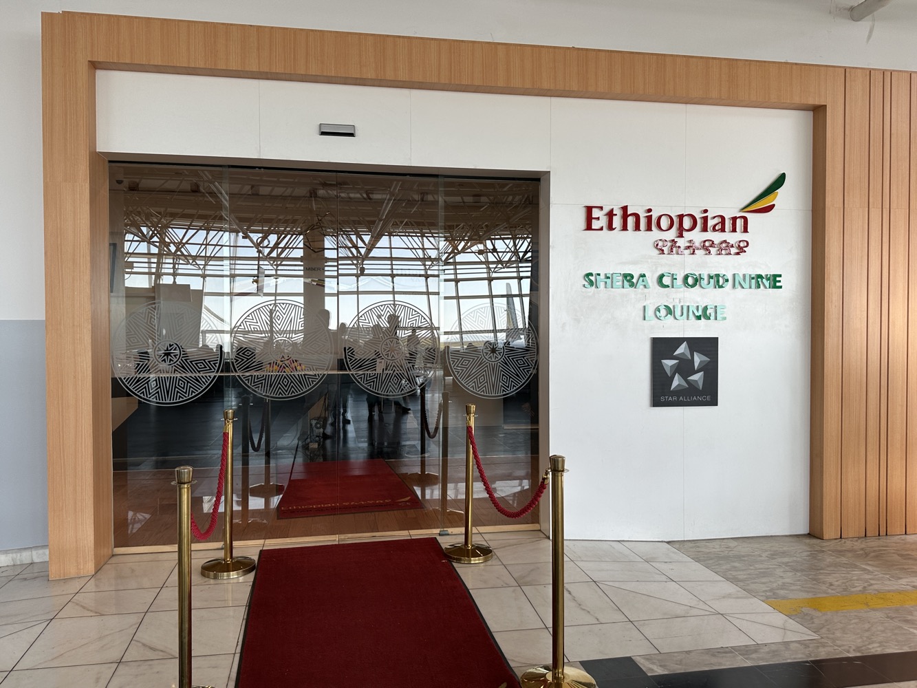 a glass door with red carpet and red carpet