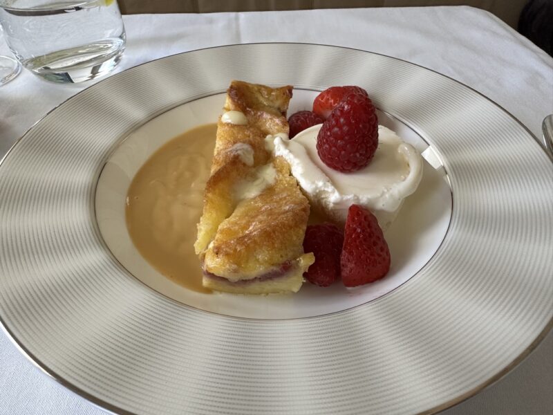 a plate of dessert with strawberries and cream