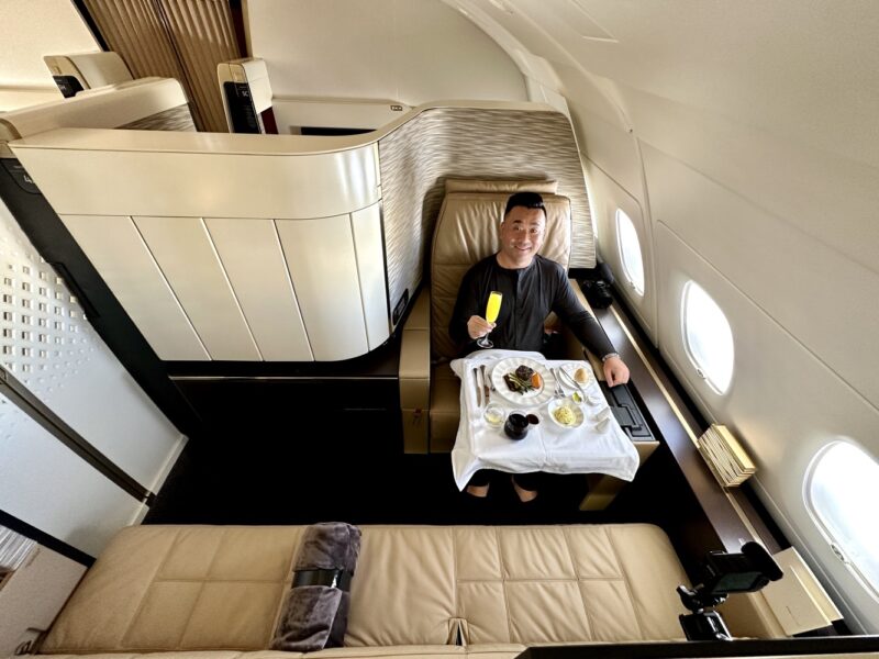 a man sitting in a chair with a table full of food