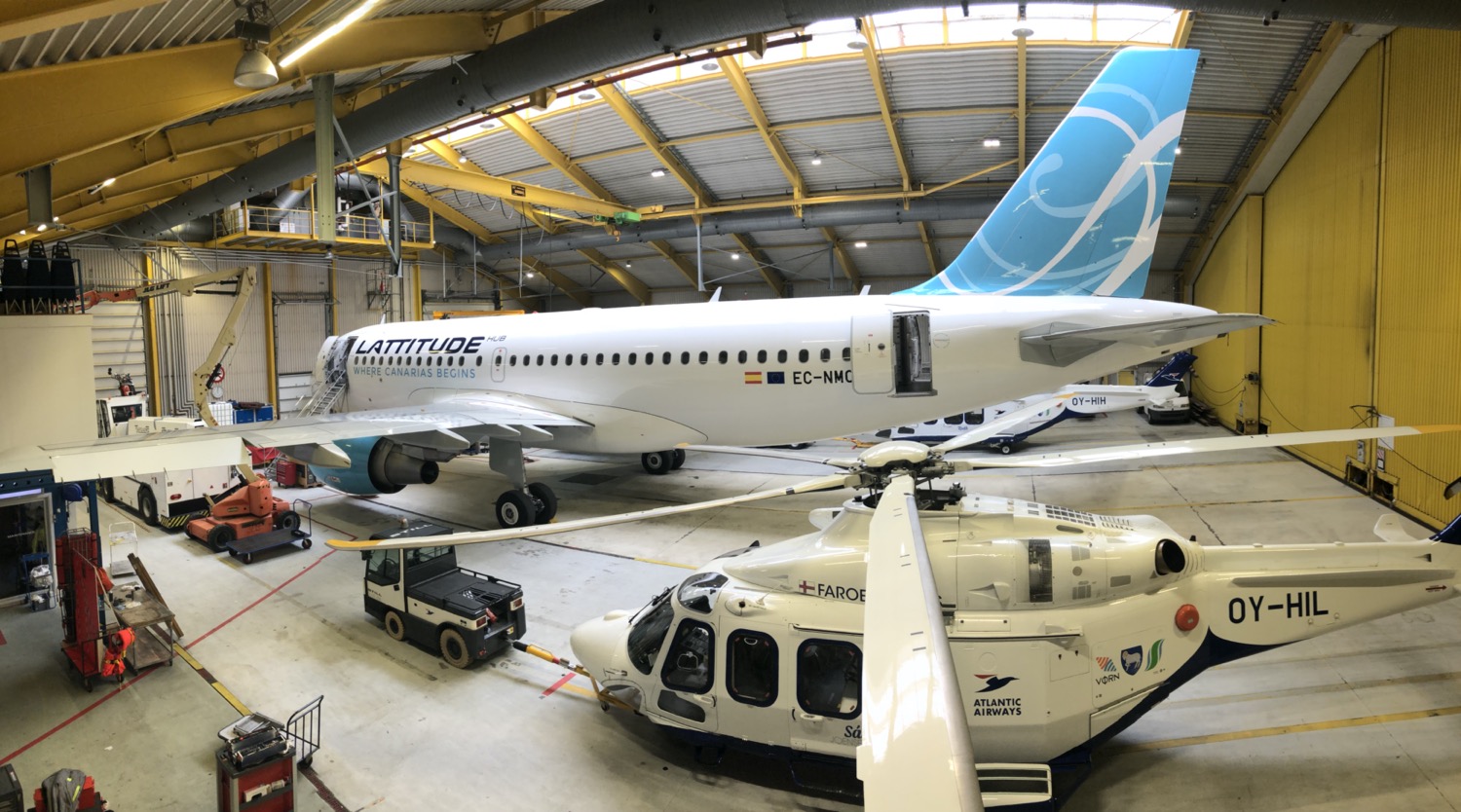 a white airplane in a hangar