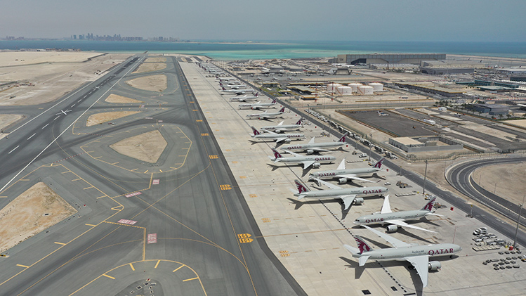 a group of airplanes parked on a runway