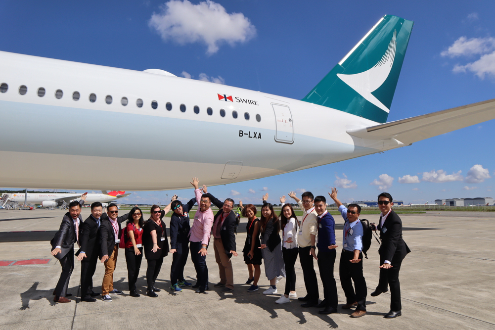 a group of people standing in front of an airplane