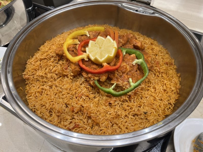 a bowl of rice with meat and vegetables