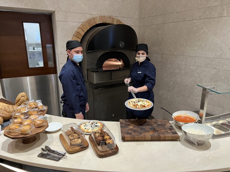 a couple of people wearing masks in a kitchen