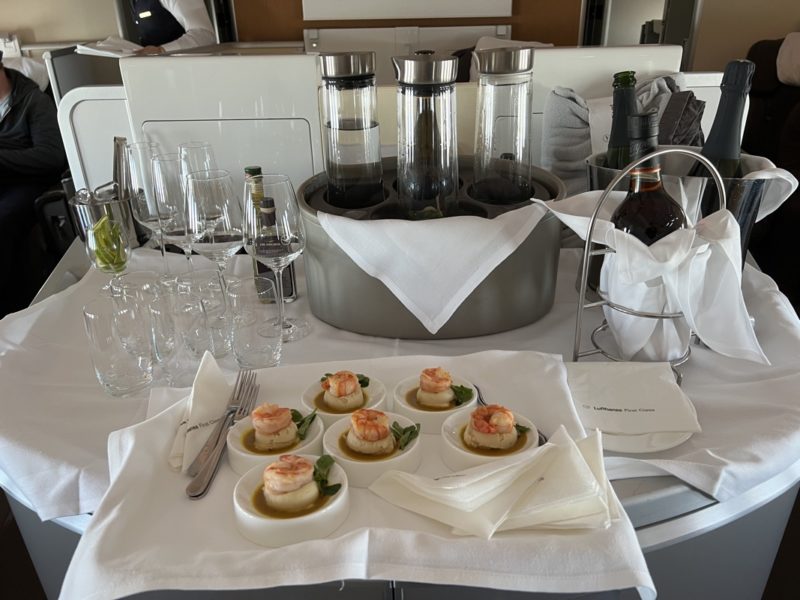 a table with a tray of food and glasses