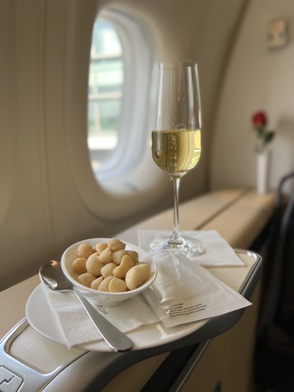 a bowl of food and a glass of champagne on a table