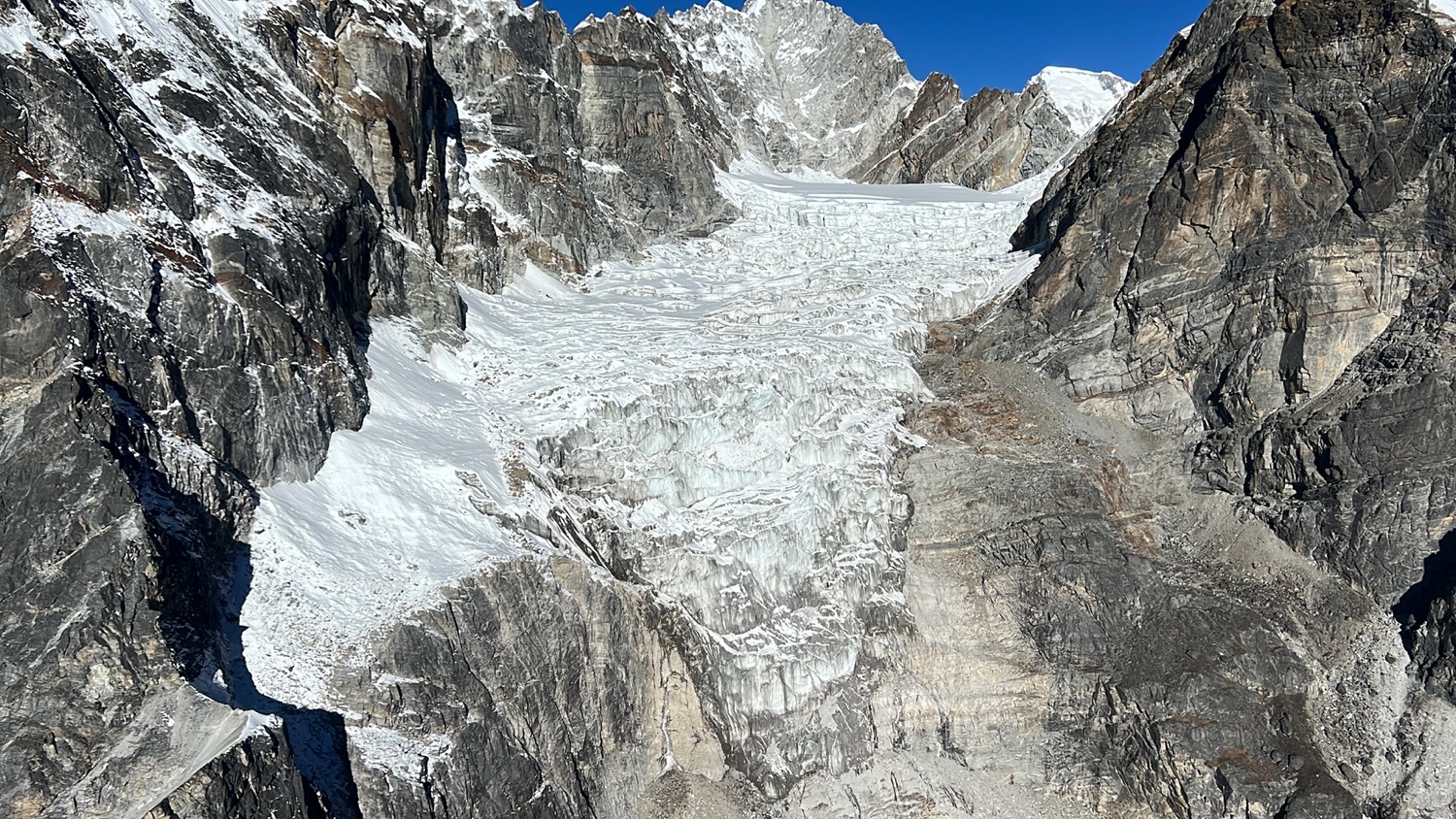 a snowy mountain with a glacier