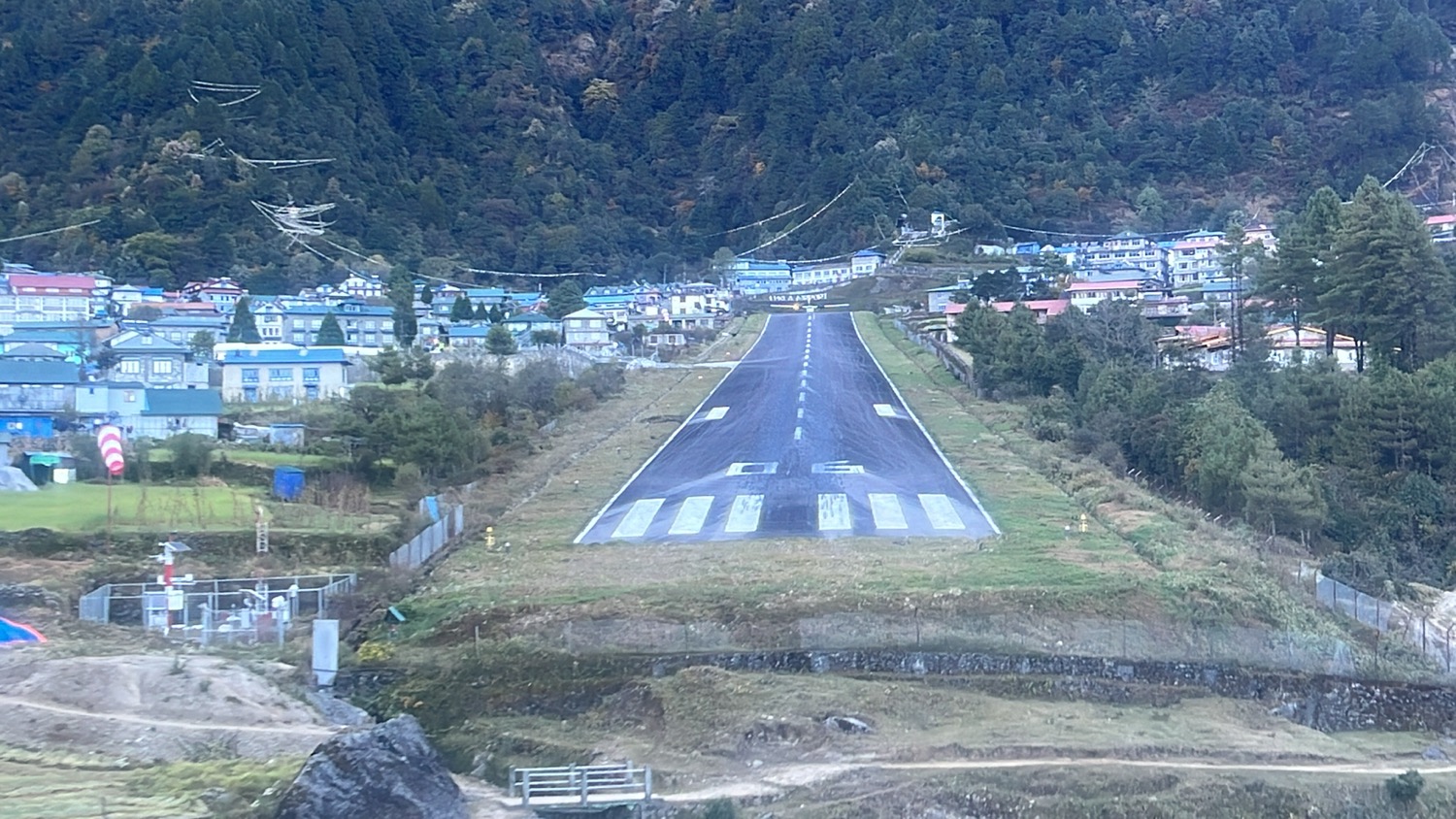 a road with a small town in the background