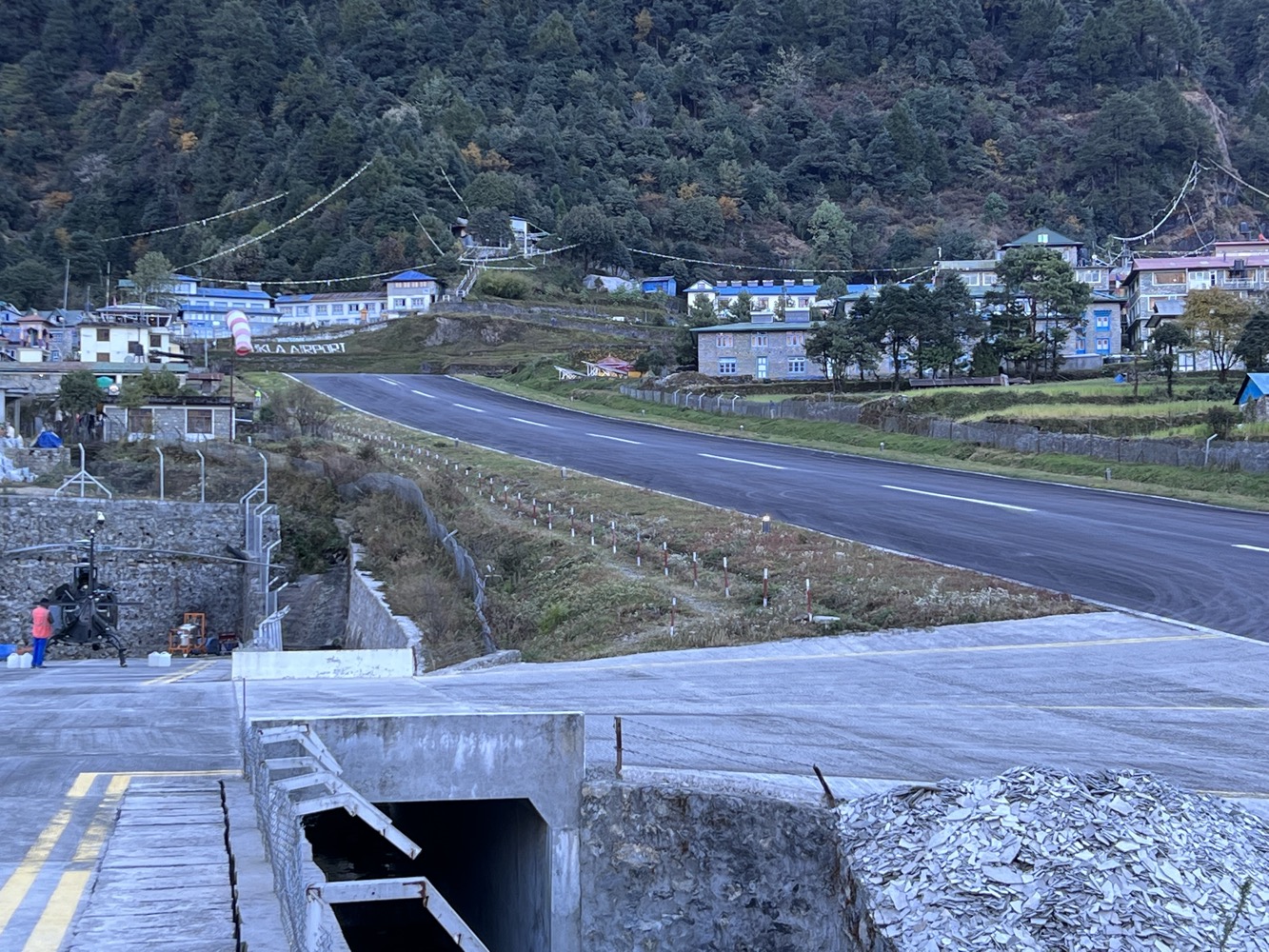 a road with buildings and trees in the background