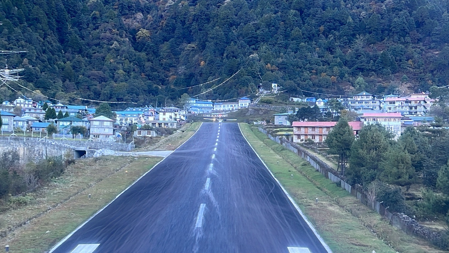 a road with houses and trees in the background