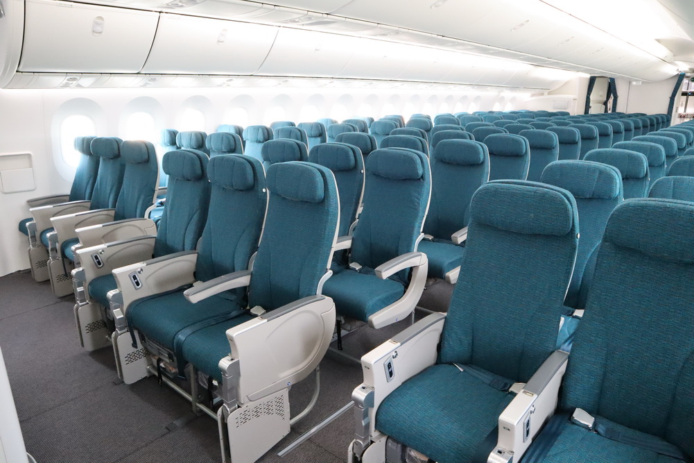 a row of blue seats in an airplane