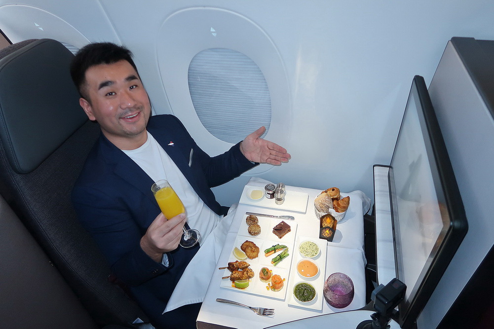 a man sitting at a table with food on it