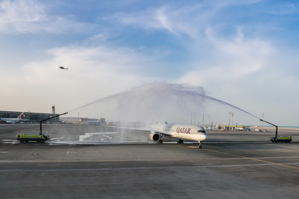 a jet plane spraying water on runway