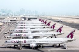 a group of airplanes parked on a runway