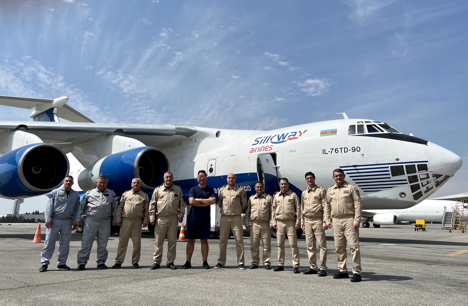 a group of people in uniform standing in front of an airplane