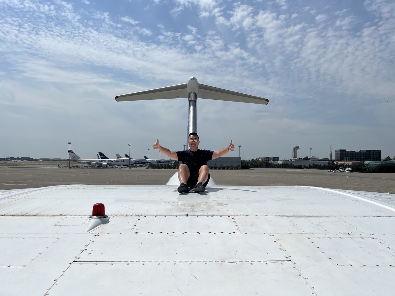 a man sitting on the wing of a plane