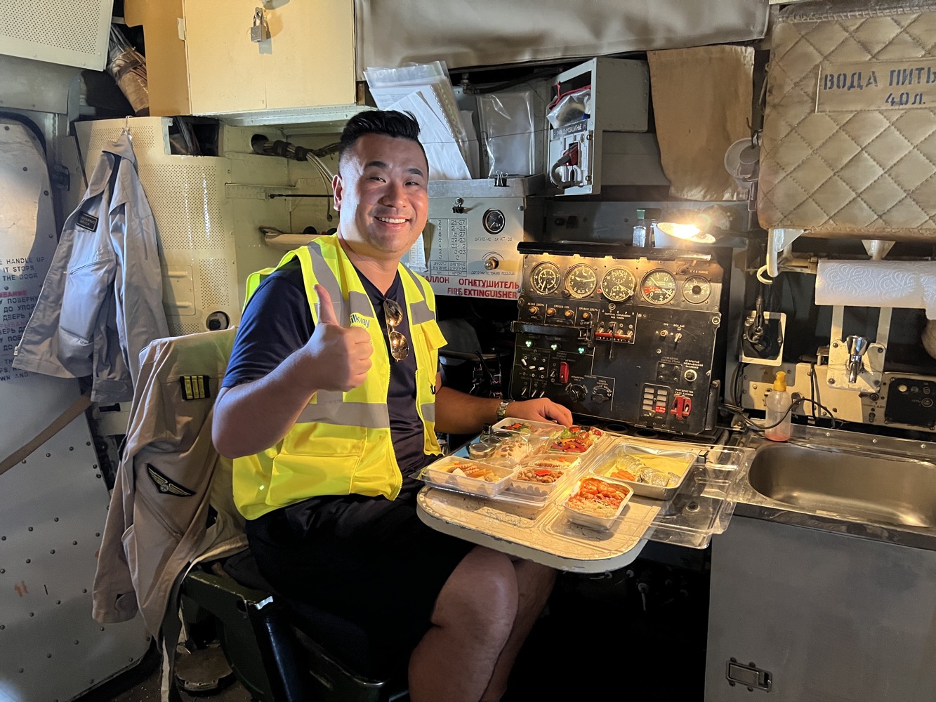 a man sitting in a chair with a tray of food