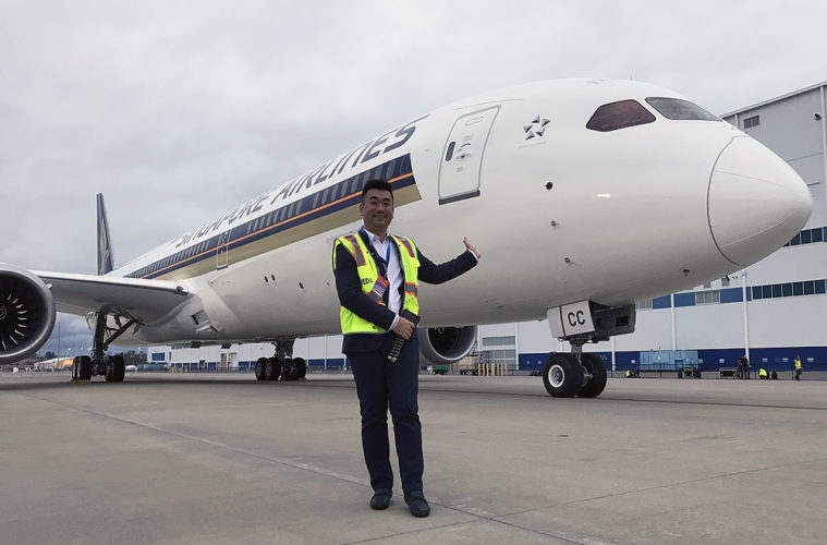 a man in a vest standing in front of an airplane