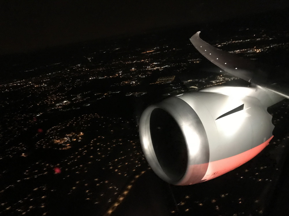 an airplane wing and a city at night