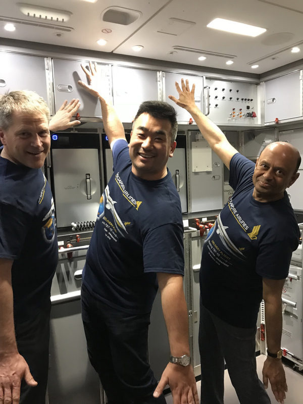 a group of men in a room with cabinets