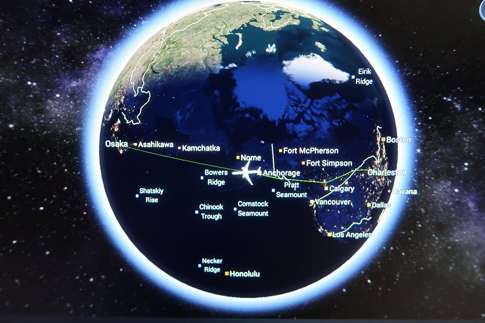 a map of the earth with a plane flying in the distance