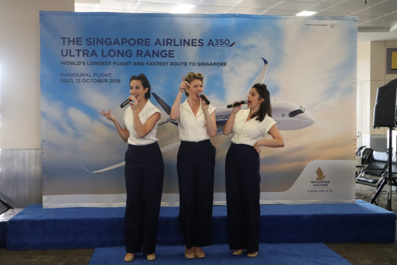 a group of women singing into microphones