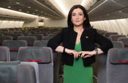 a woman standing in an airplane