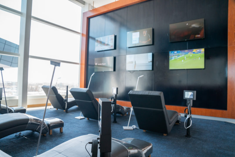 a room with chairs and televisions