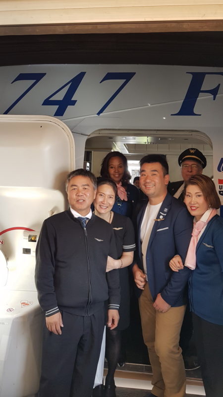 a group of people standing in front of an airplane